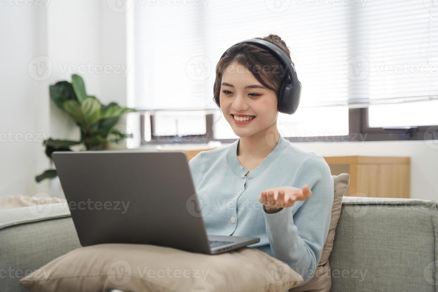 Portrait of Asian woman sitting on sofa at home photo