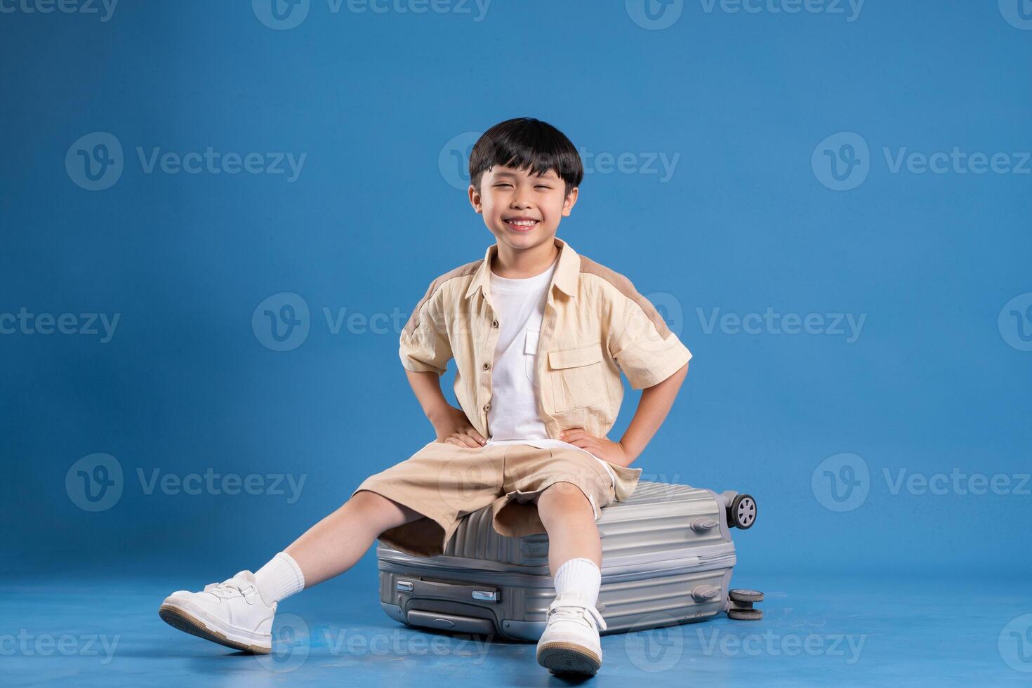 Portrait of asian boy posing on blue background photo
