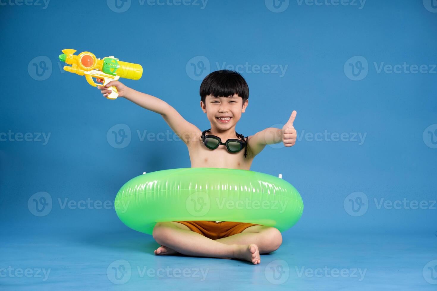 Portrait of asian boy posing on blue background photo