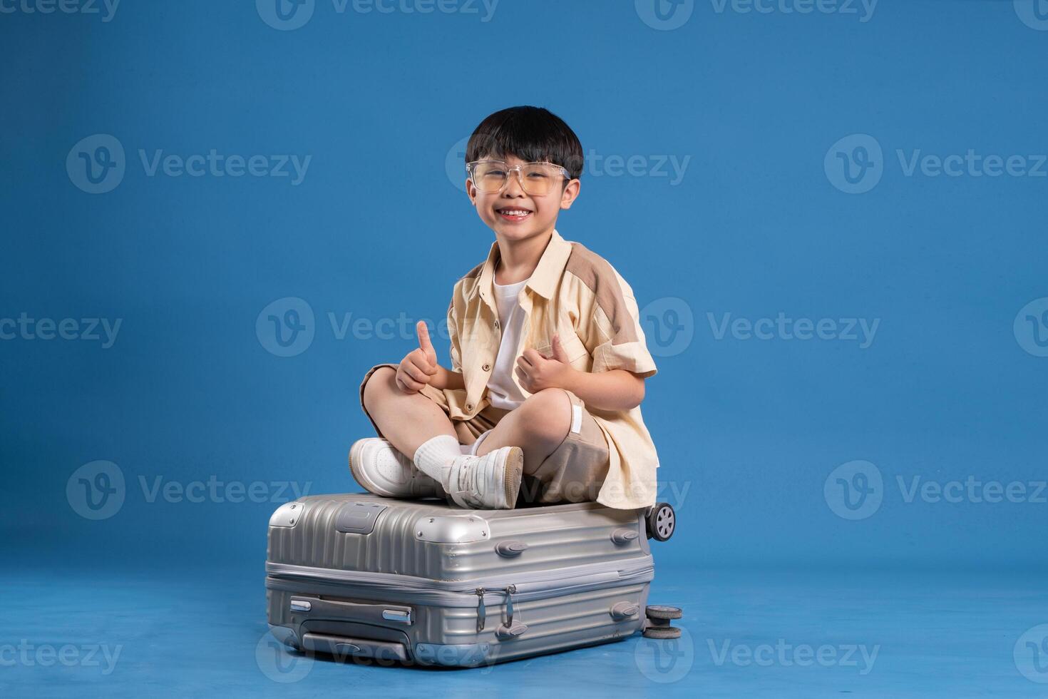 Portrait of asian boy posing on blue background photo
