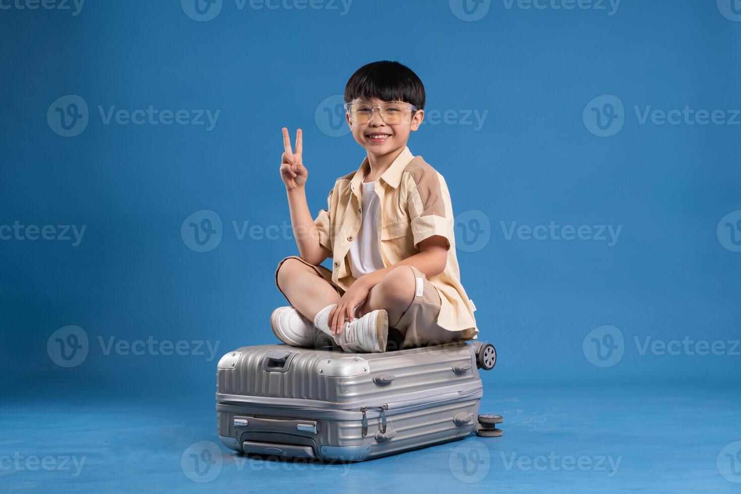 Portrait of asian boy posing on blue background photo