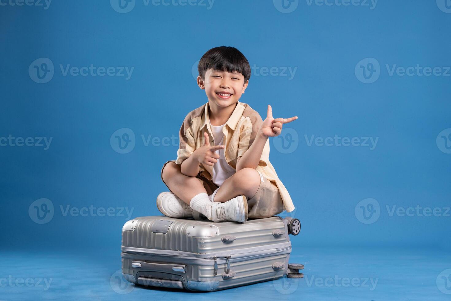Portrait of asian boy posing on blue background photo