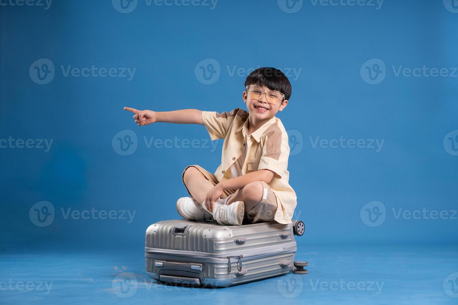 Portrait of asian boy posing on blue background photo