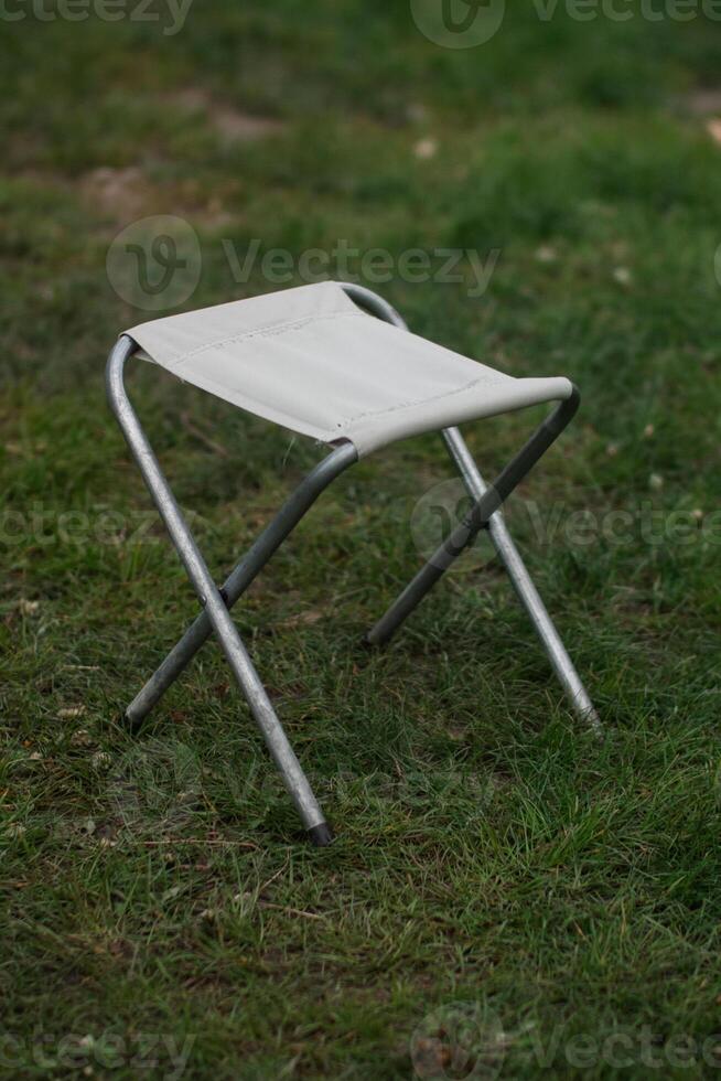 Folding Camping Chair Standing on Grass photo