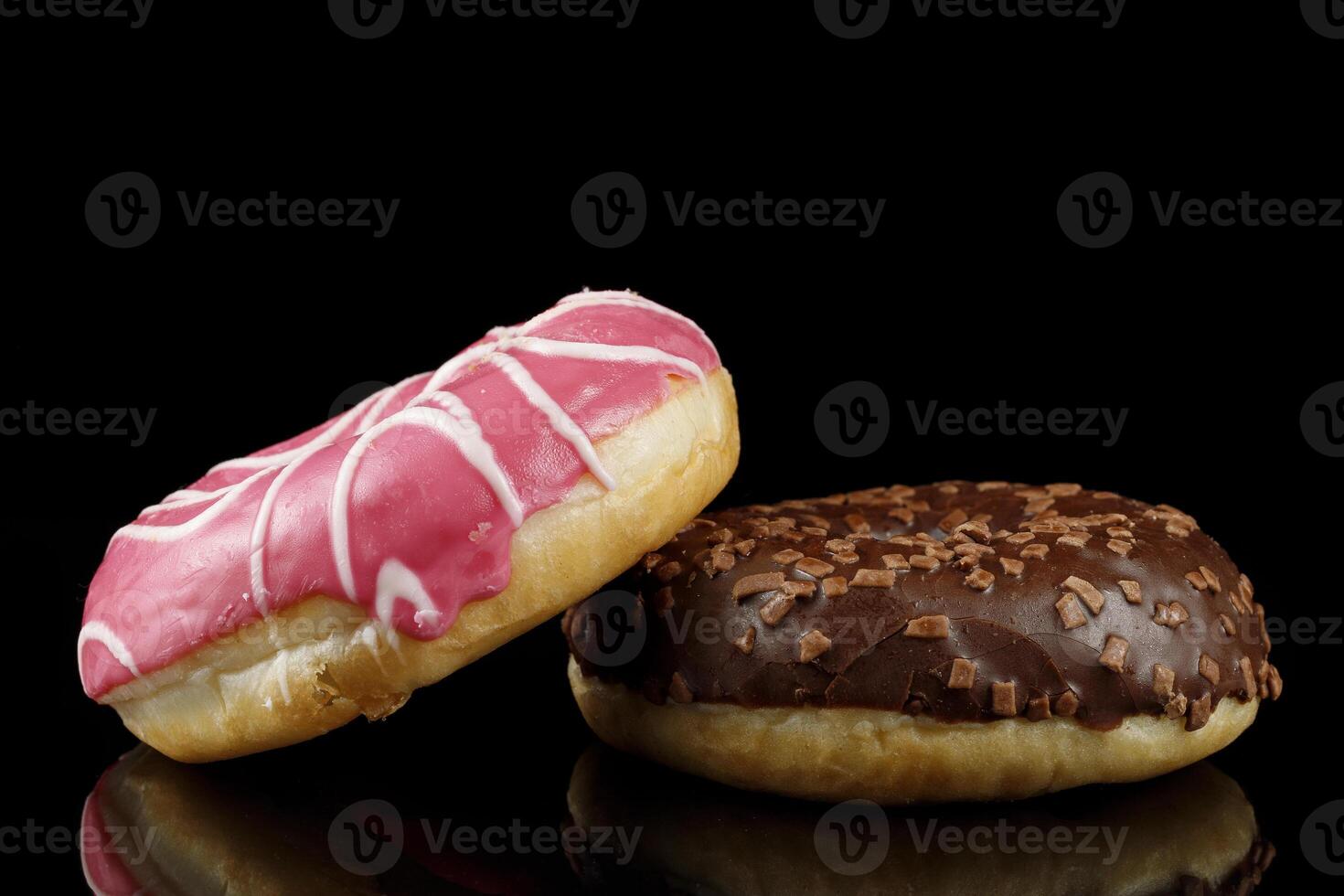Donuts close-up on a dark background. Delicious pastries. photo