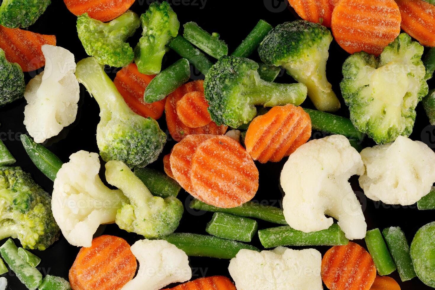 Frozen vegetables close-up on black. photo