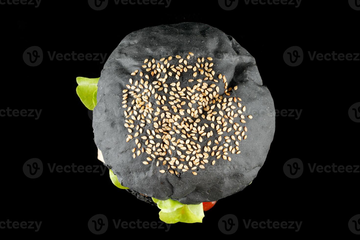 Black burger with lettuce, tomato, cheese and cutlet top view. photo