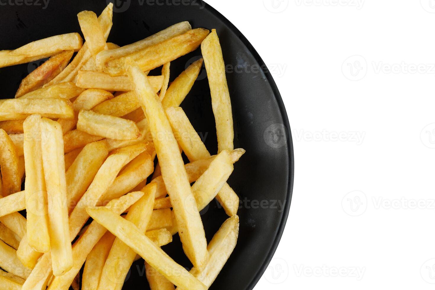 French fries in a black plate isolate. Appetizing fried potatoes. place for text cope space photo