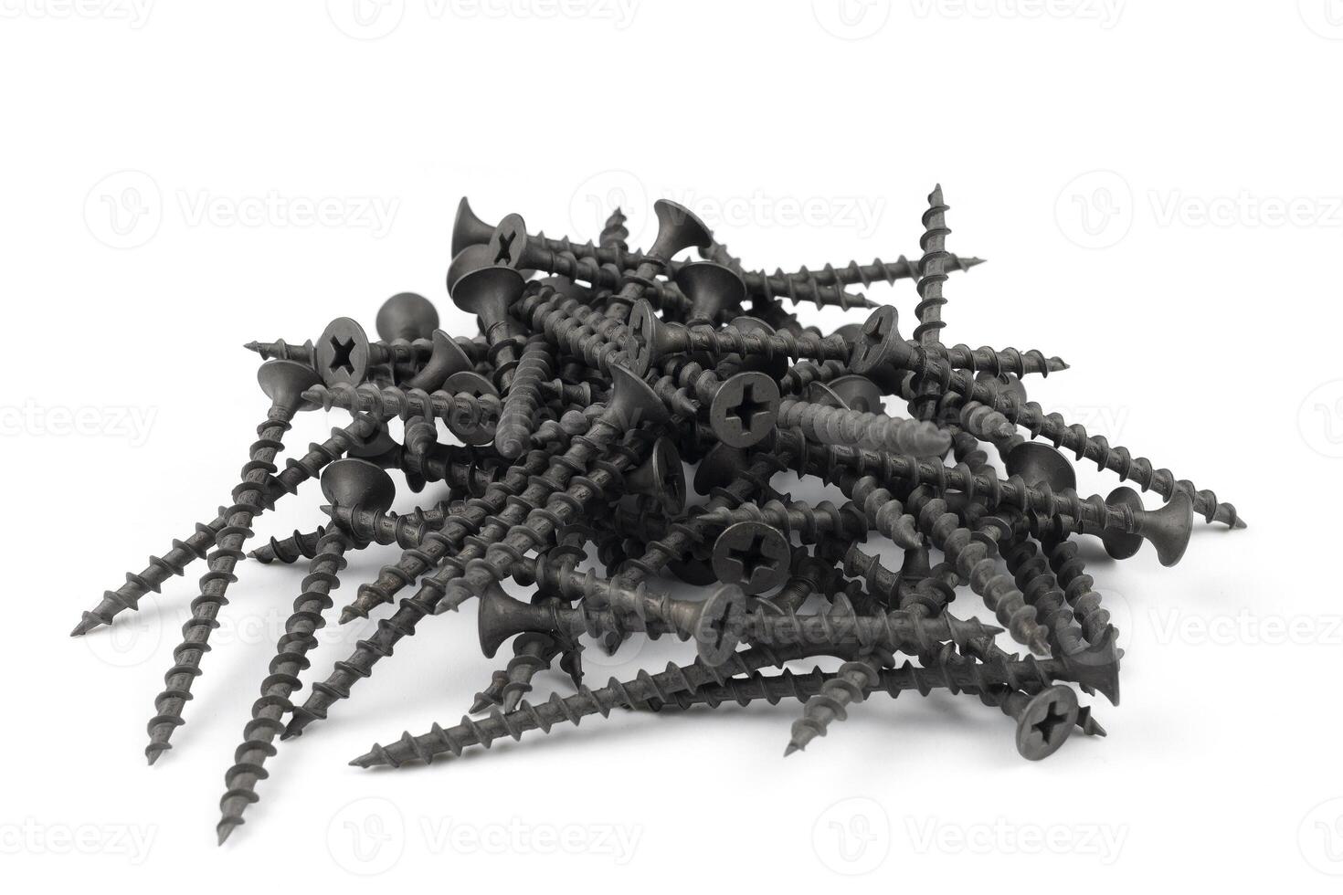 Screws on white. black metal screws pile isolated on the white background photo