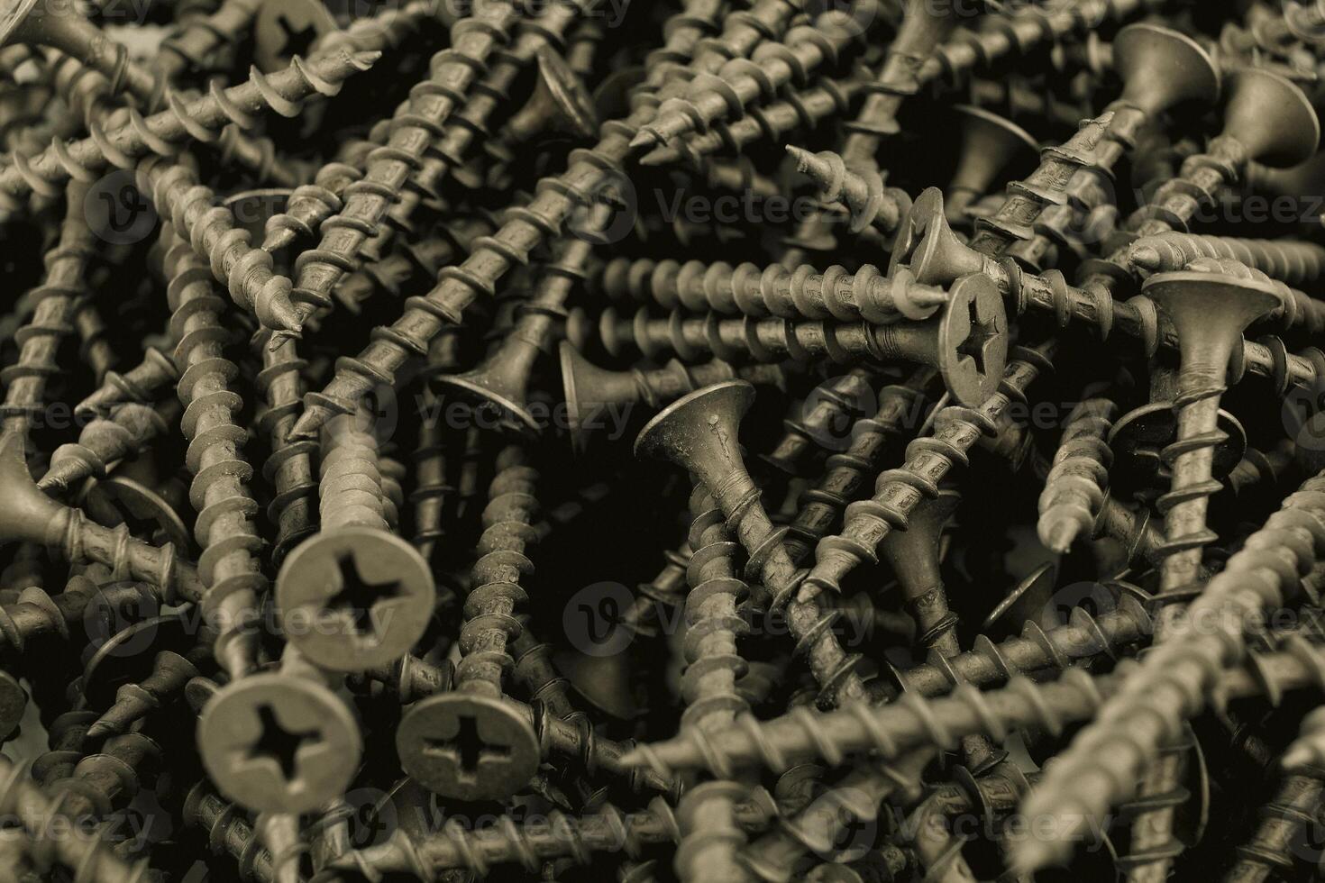 screws for wood close-up. many black screws. Background from steel screws photo