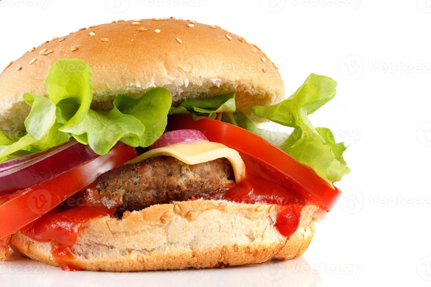 Tasty burger close-up place for text cope space. Burger with tomatoes, greens, onions and meat. photo
