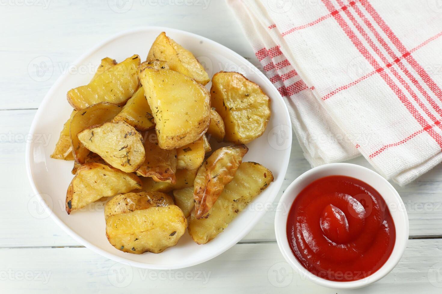Fried potatoes on a white plate. Potato dish in a restaurant. photo