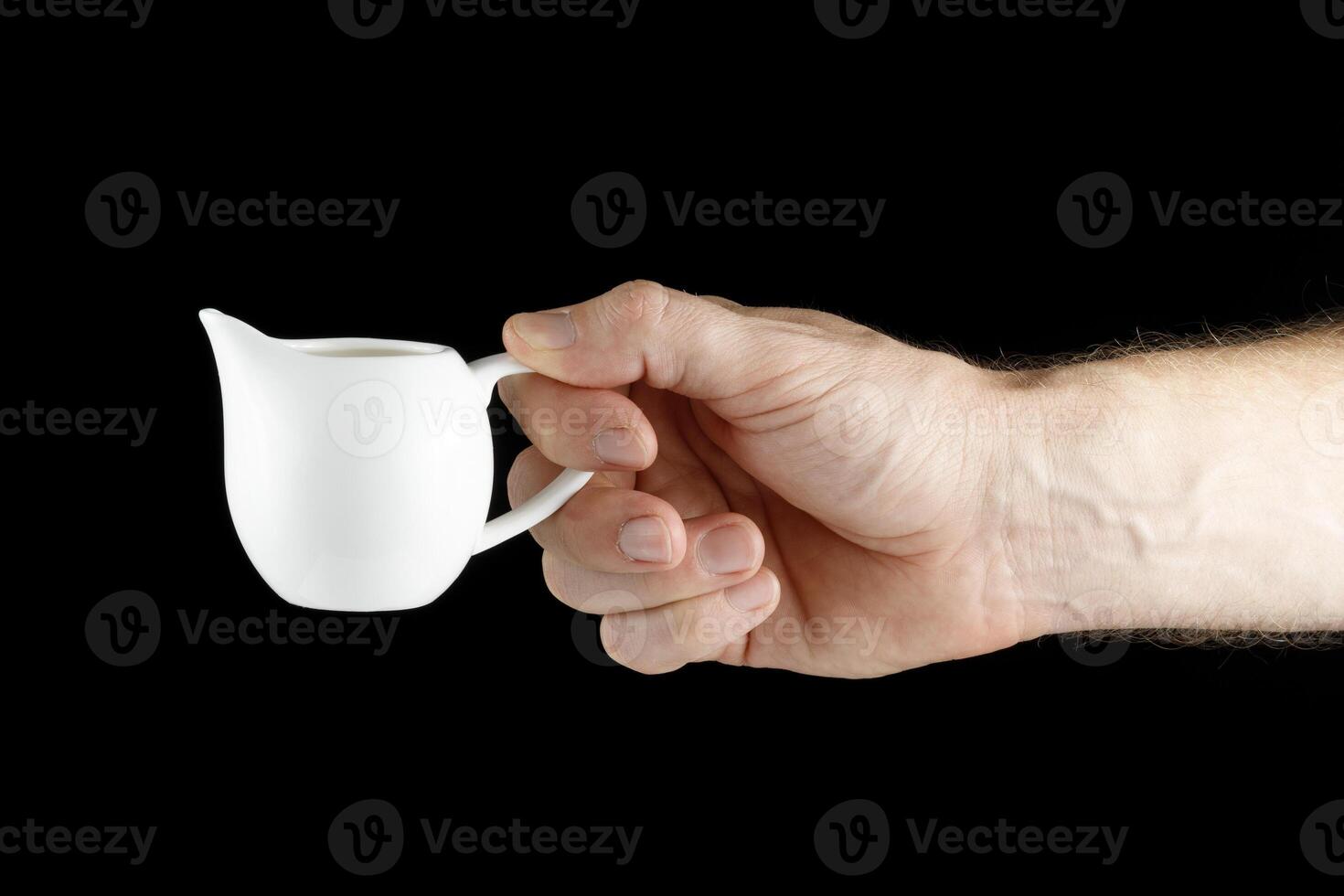 A white man's hand holds a Creamer isolate photo