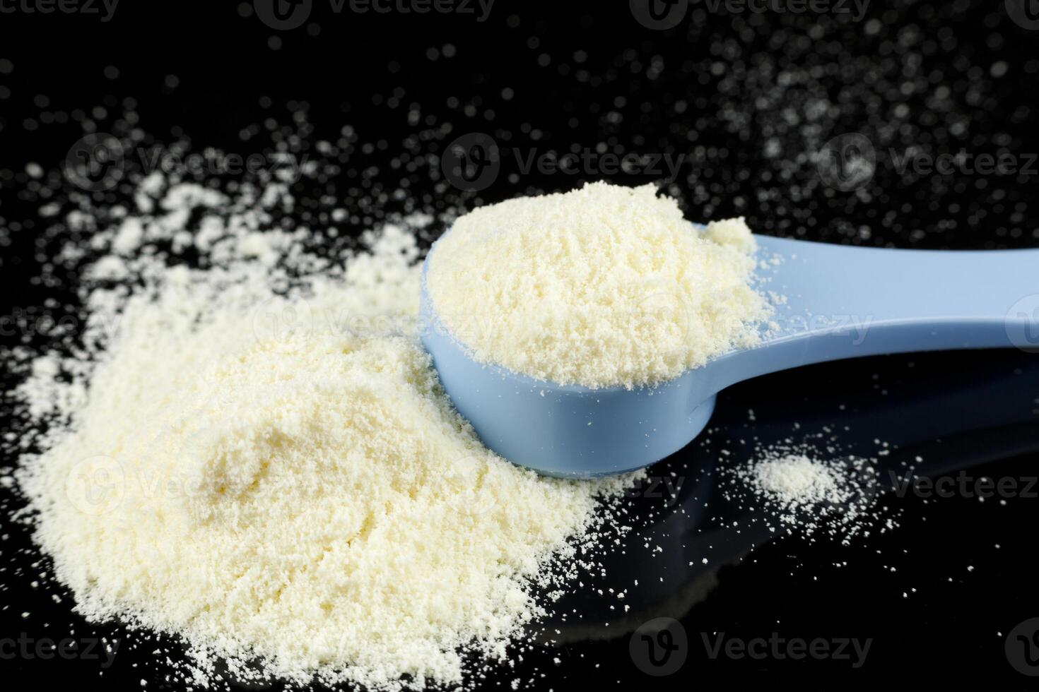 Baby food and a blue spoon. Yellow powder for baby food. photo