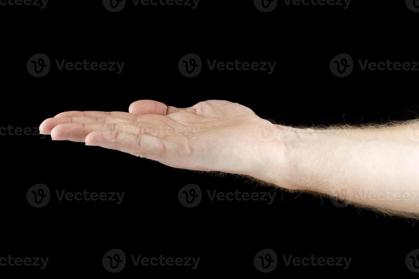 Hand and open palm on black isolate. Caucasian male hand. photo