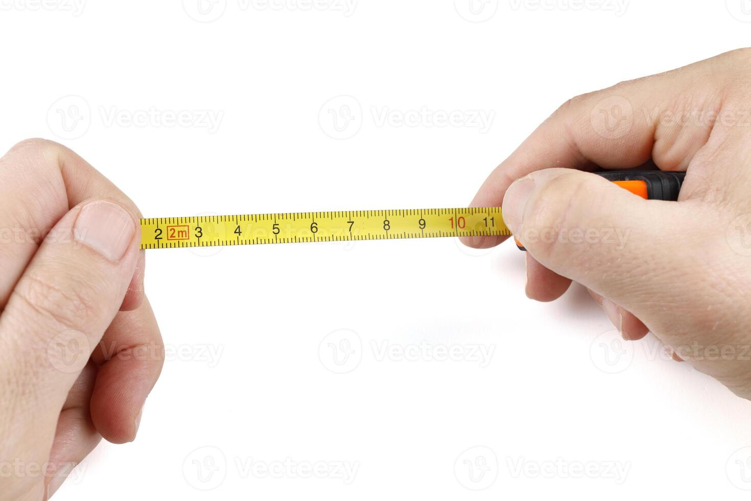 Self-retracting metal tape measure in hands. Man with measuring tape on white background photo
