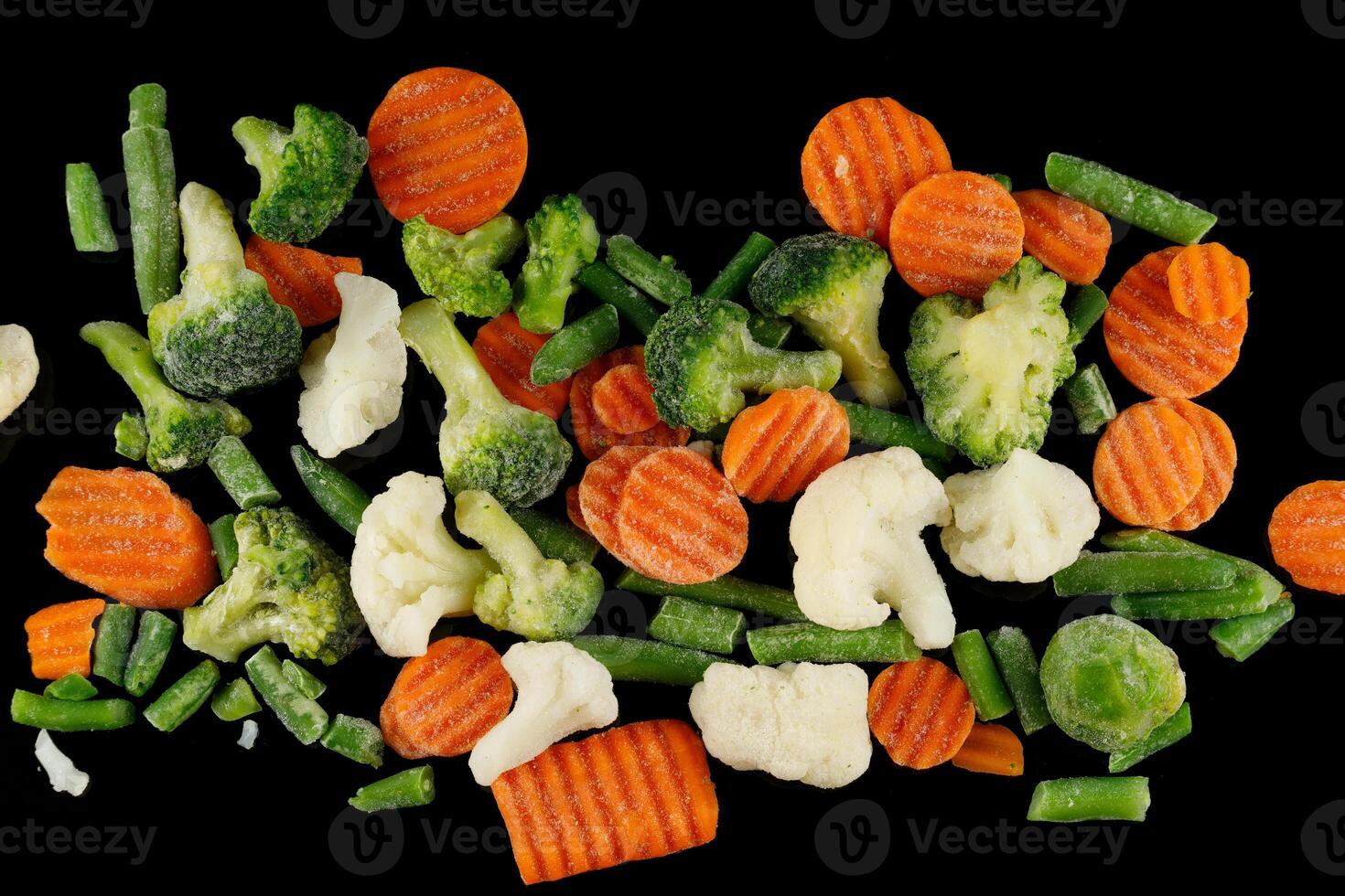 Frozen vegetables close-up on black. photo