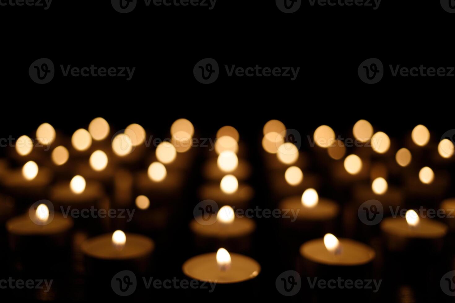 Many burning candles on a black background. burning candles on black background Christmas background photo