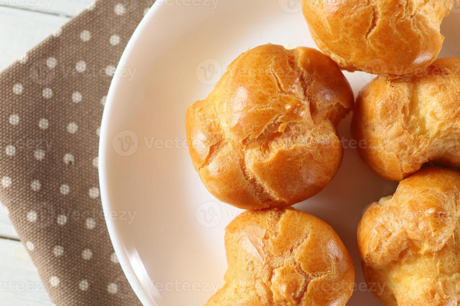 Eclairs in a white plate close-up. Delicious traditional breakfast. photo