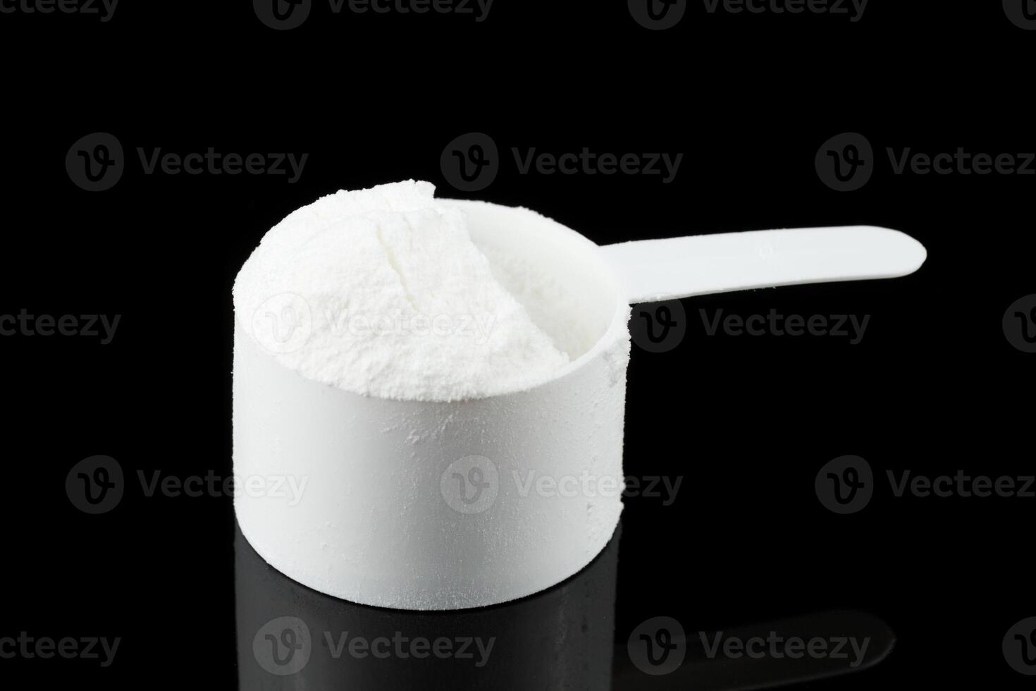 Gainer in a spoon. Sports nutrition and a measuring spoon photo