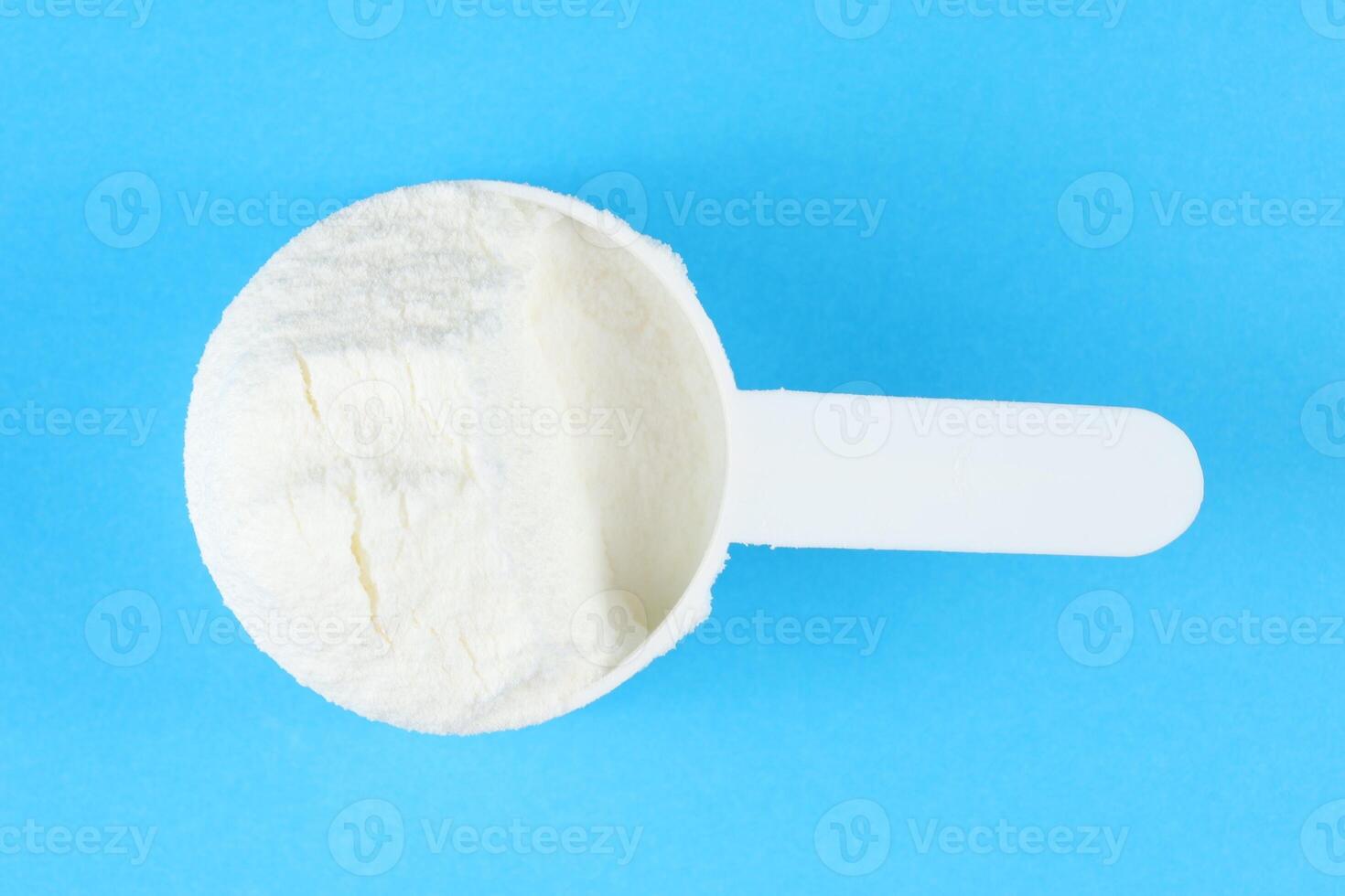 Sports nutrition in powder and a measuring spoon. photo