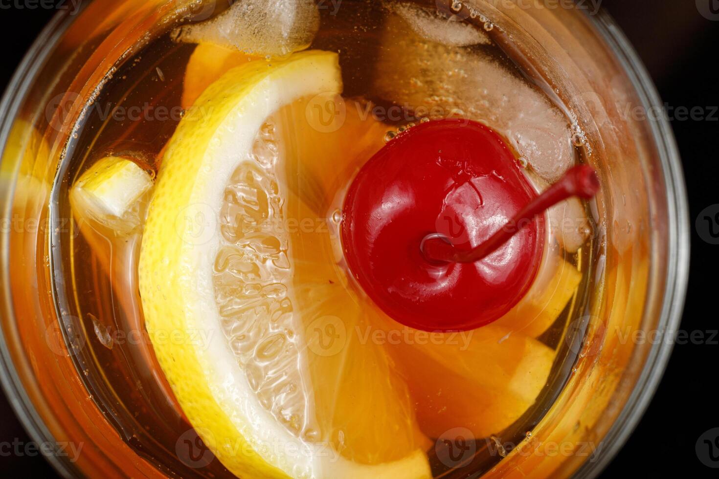 Lemon cocktail with cherry, honey and ice. photo