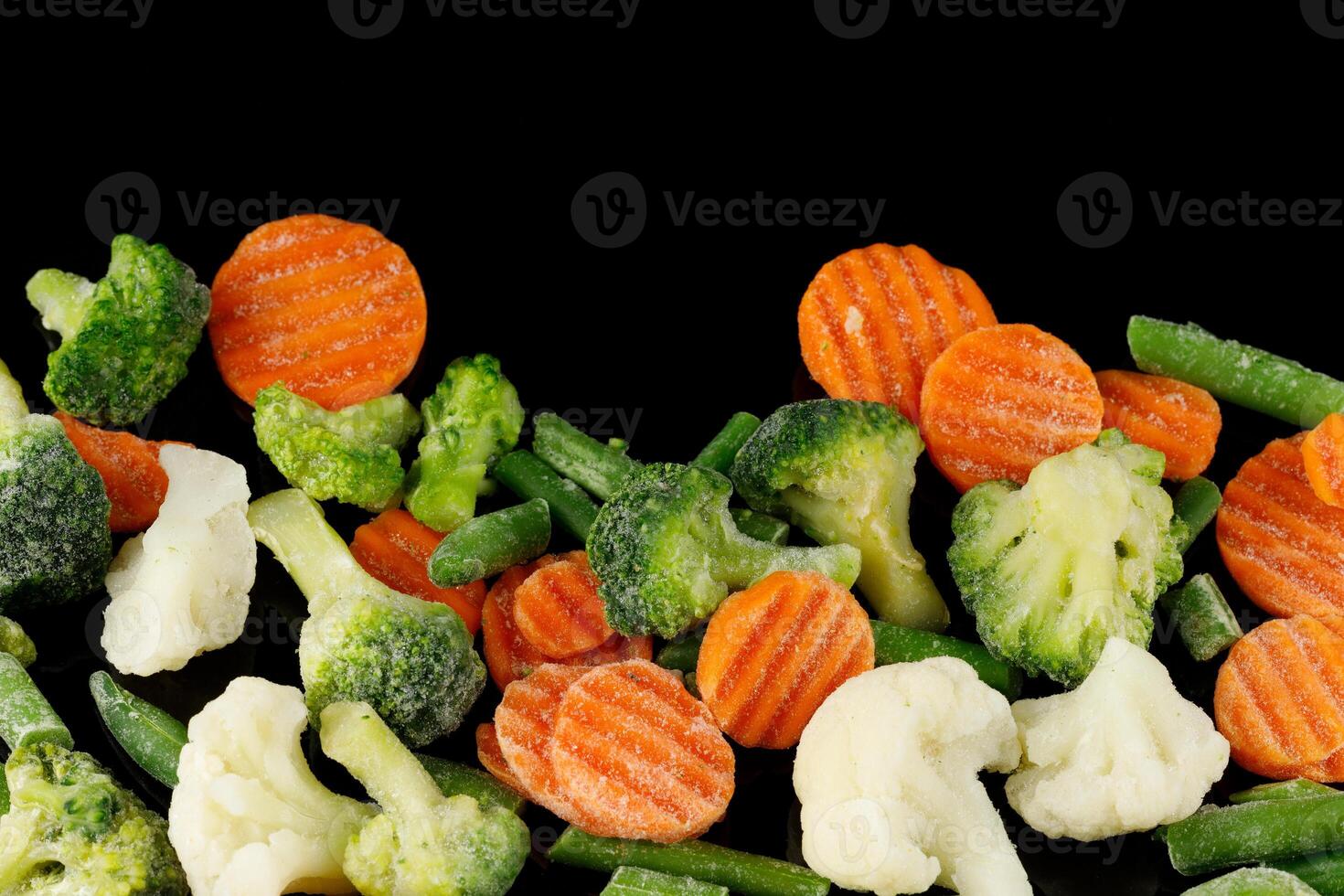 Frozen vegetables close-up on black. photo