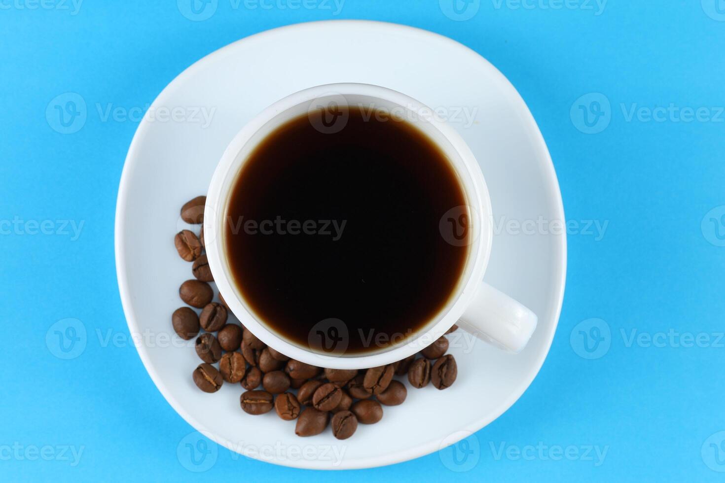 Coffee in a white cup and coffee beans photo