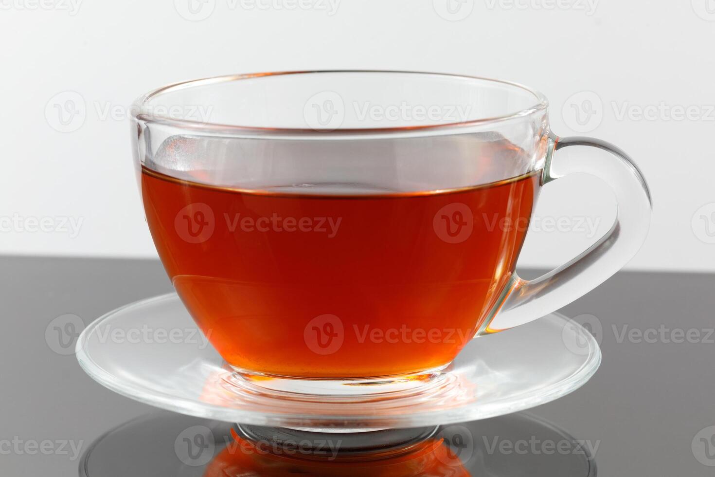 Black tea in a cup on a gray background. photo