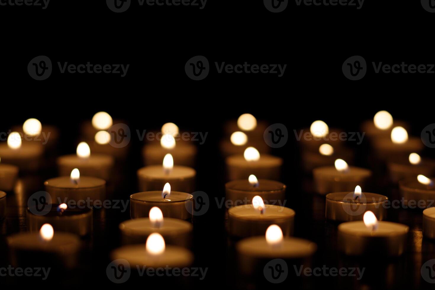 Many burning candles on a black background. burning candles place for text cope space photo