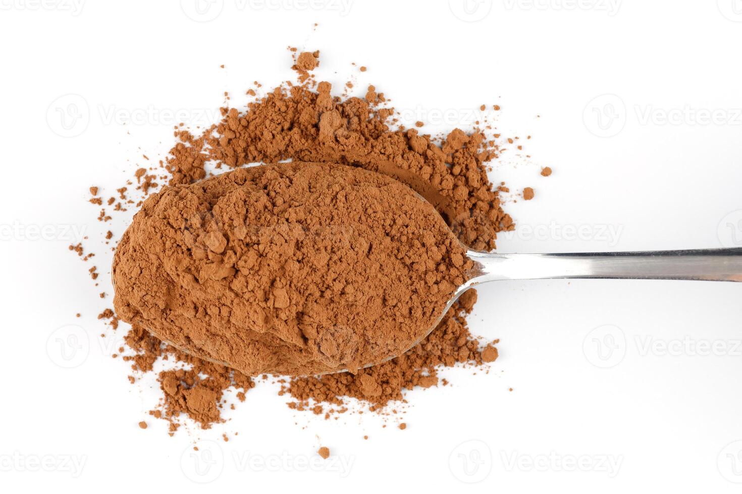 Cocoa powder on a spoon isolate photo