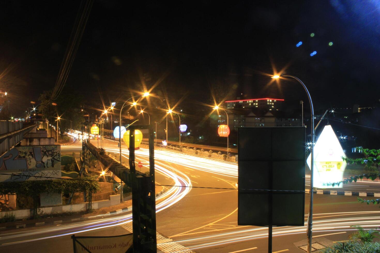 time lapse or long exposure photography of traffic on the street at night and railway train photo