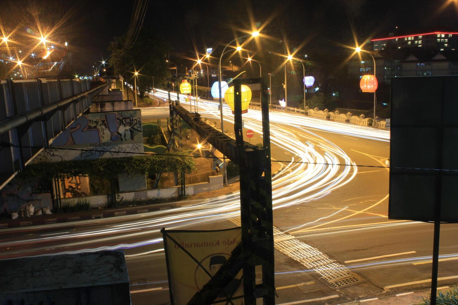 time lapse or long exposure photography of traffic on the street at night and railway train photo