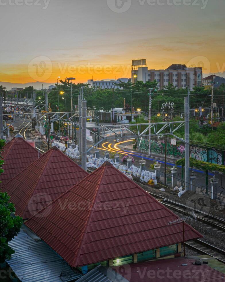 view of the city at sunset in yogyakarta city with train or railroads photo