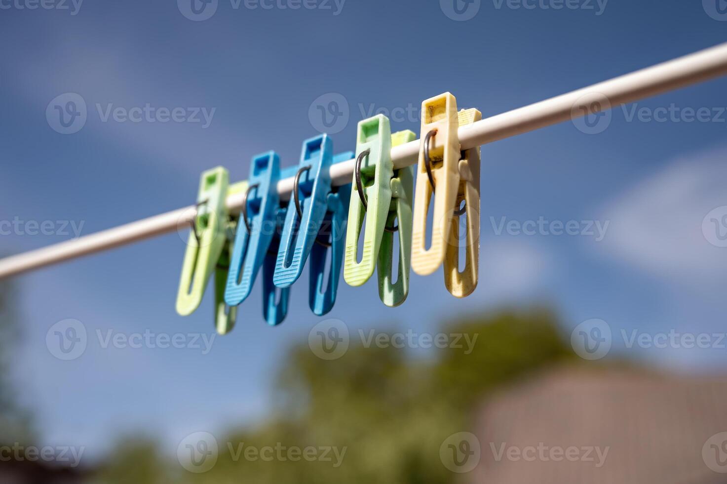 clothespins on a clothesline against the blue sky in spring photo