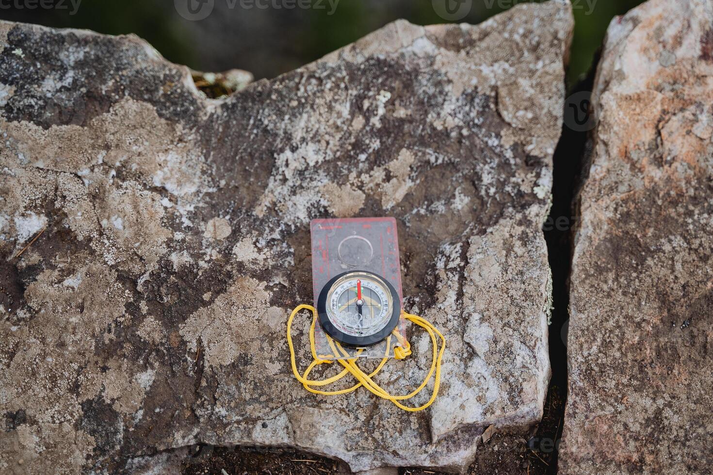 Compass plastic with transparent glass, the device for orientation on the terrain, shows the north of the arrow. photo