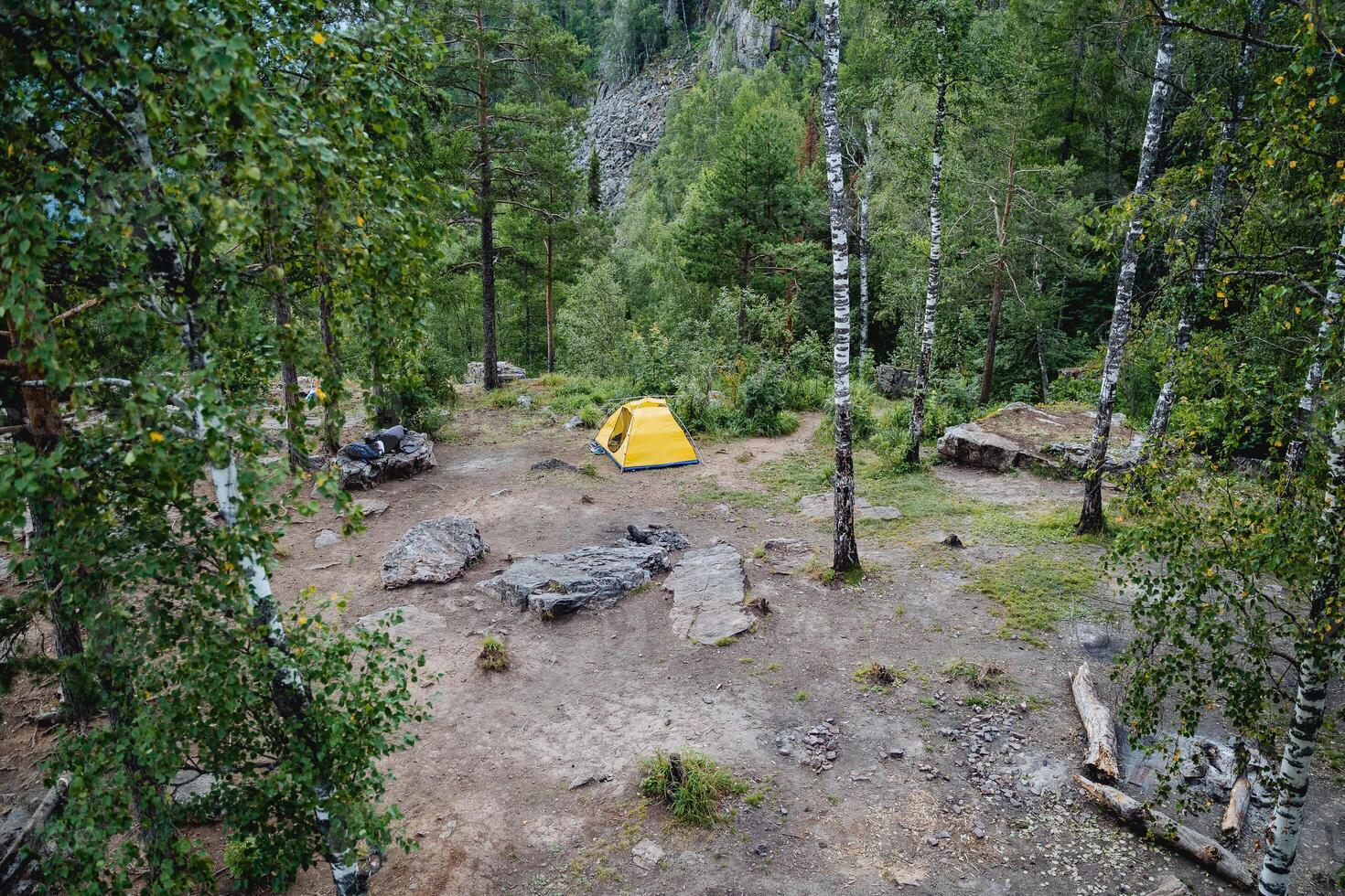 Camping tourist parking in the forest, yellow tent, place to relax in nature, house for overnight stay in the forest. photo