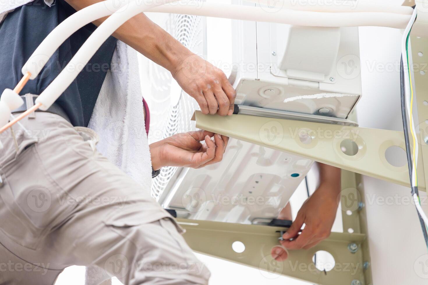 Repairman service for repair and maintenance of air conditioners, Technician team install new air conditioning photo