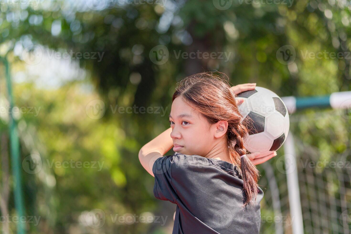 Asian child girl with soccer ball, Kid girl playing football photo