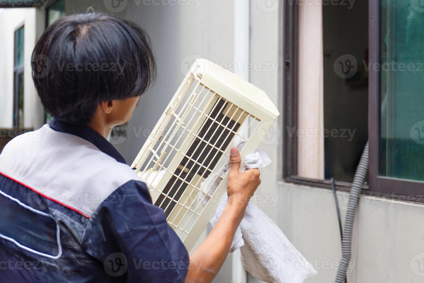 Technician man team cleaned mold in the air conditioning system, Repairman washed dirty inside compartments air conditioner, Maintenance and service concepts photo