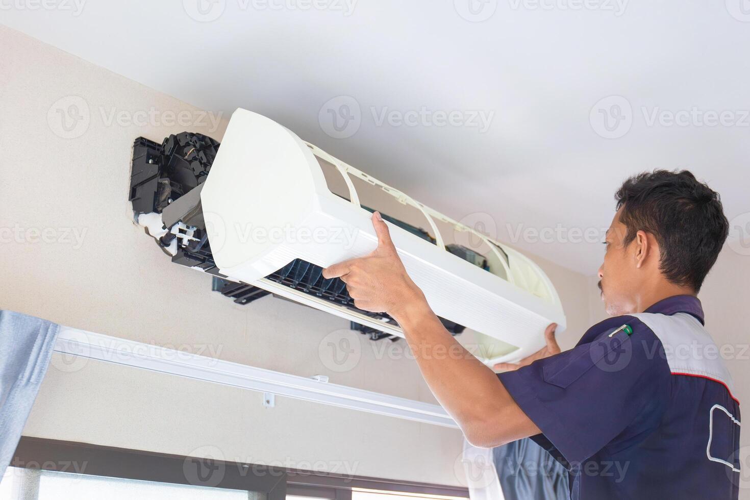 Technician man cleaned mold in the air conditioning system, Repairman washed dirty inside compartments air conditioner, Maintenance and service concepts photo