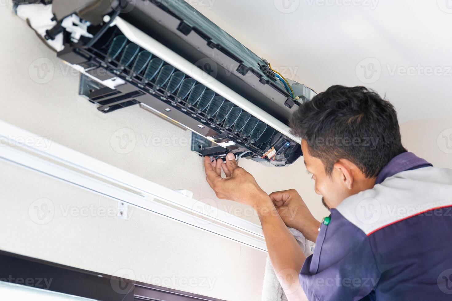 Technician man cleaned mold in the air conditioning system, Repairman washed dirty inside compartments air conditioner, Maintenance and service concepts photo