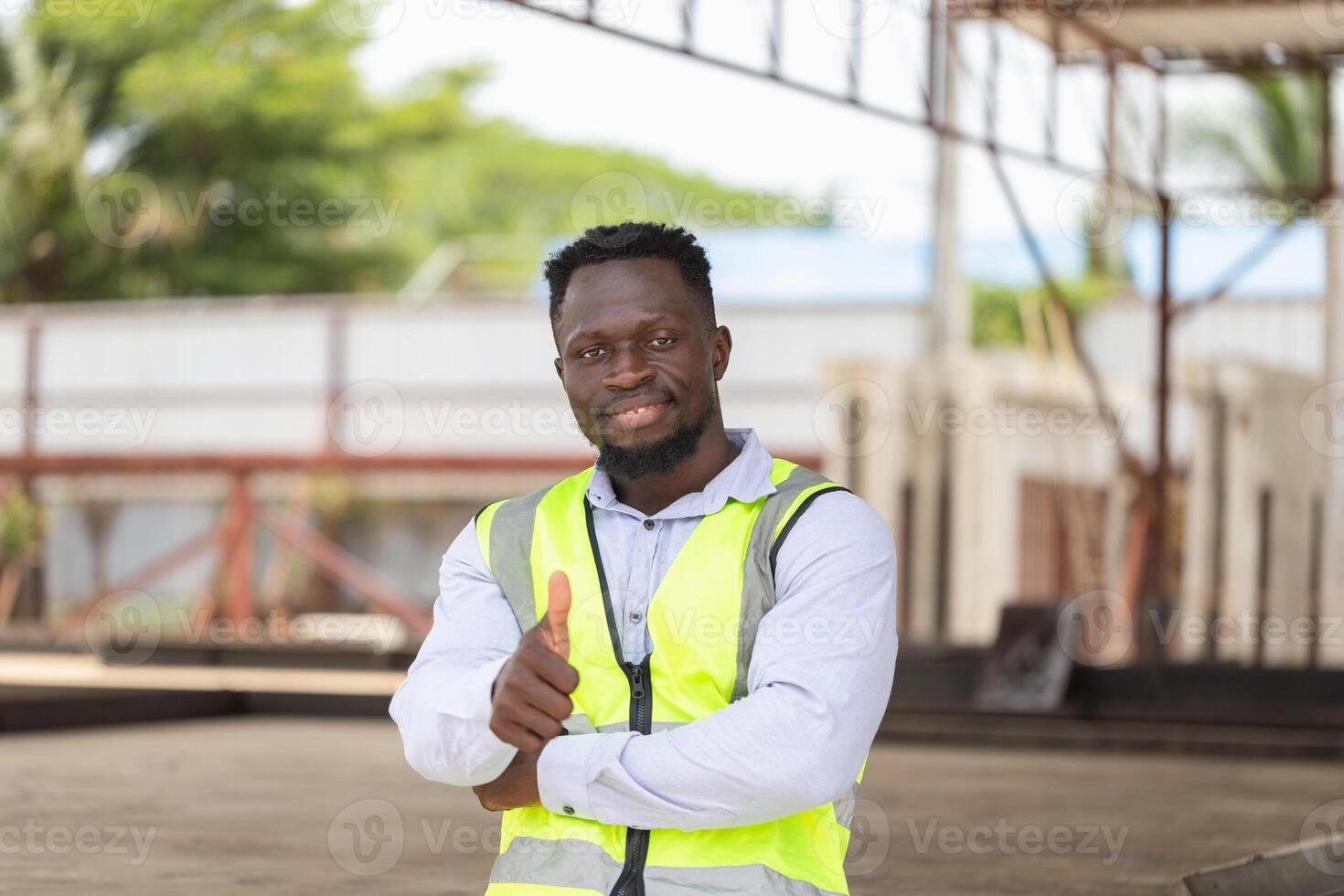 Engineer man showing thumbs up on construction site, Foreman showing thumb up like gesture photo