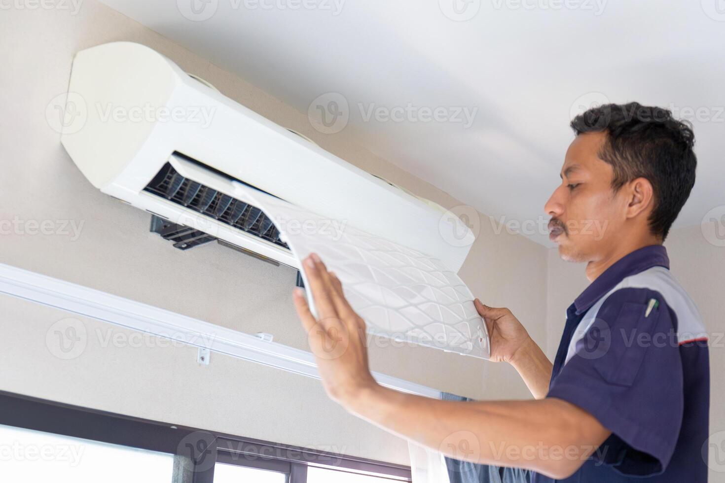 Technician man cleaned mold in the air conditioning system, Repairman washed dirty inside compartments air conditioner, Maintenance and service concepts photo