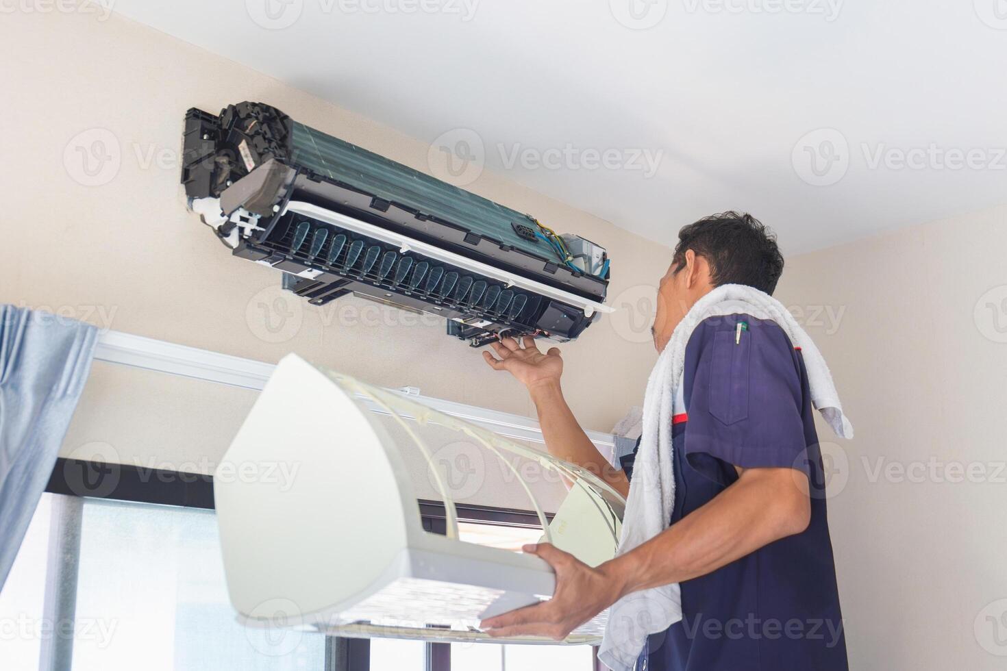 Technician man cleaned mold in the air conditioning system, Repairman washed dirty inside compartments air conditioner, Maintenance and service concepts photo