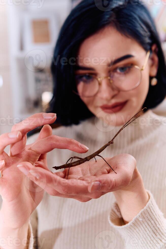 Young Woman Captured in a Beautiful Moment with Her Stick Insect , Medauroidea Extradentata photo