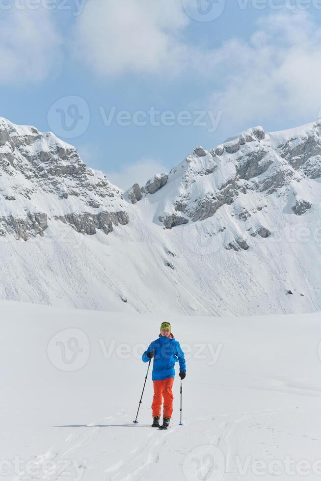 A Skier Scales a Treacherous Alpine Peak photo