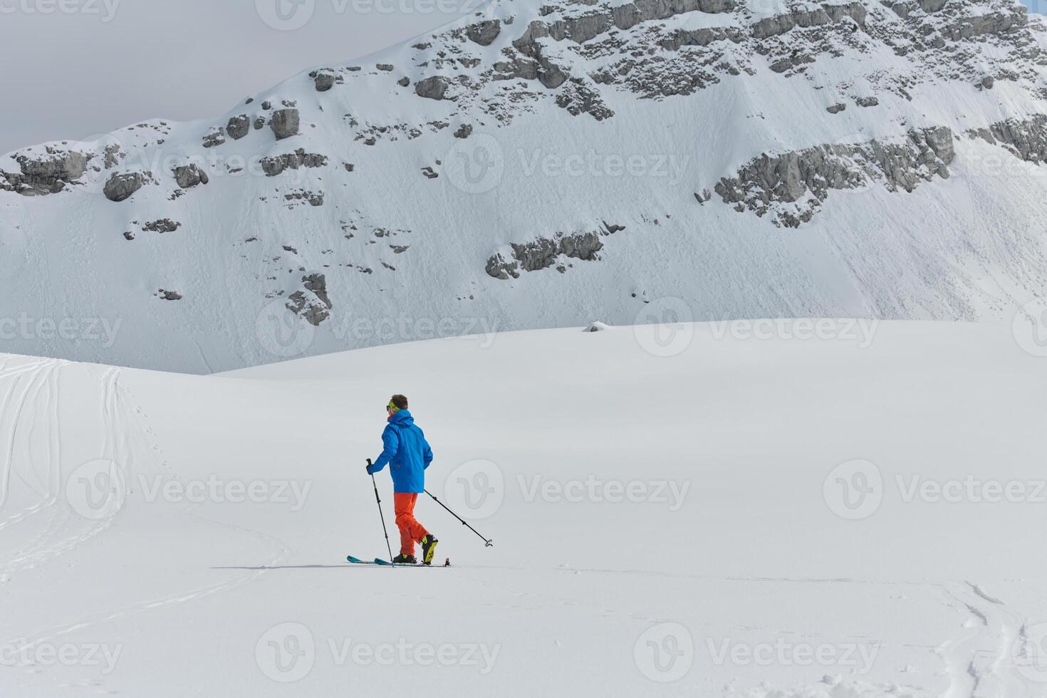 A Skier Scales a Treacherous Alpine Peak photo