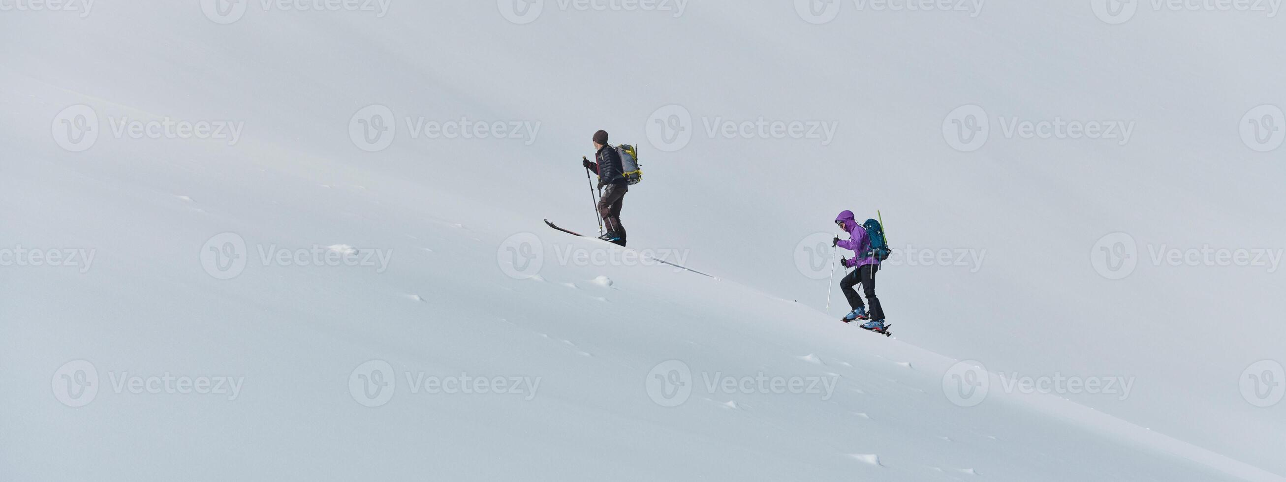 Alpine Ascent. Two Professional Skiers Conquer Snowy Peaks as a Determined Team. photo