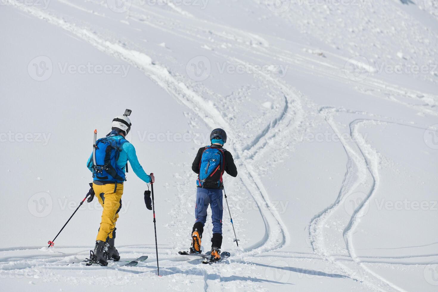 Alpine Ascent. Two Professional Skiers Conquer Snowy Peaks as a Determined Team. photo